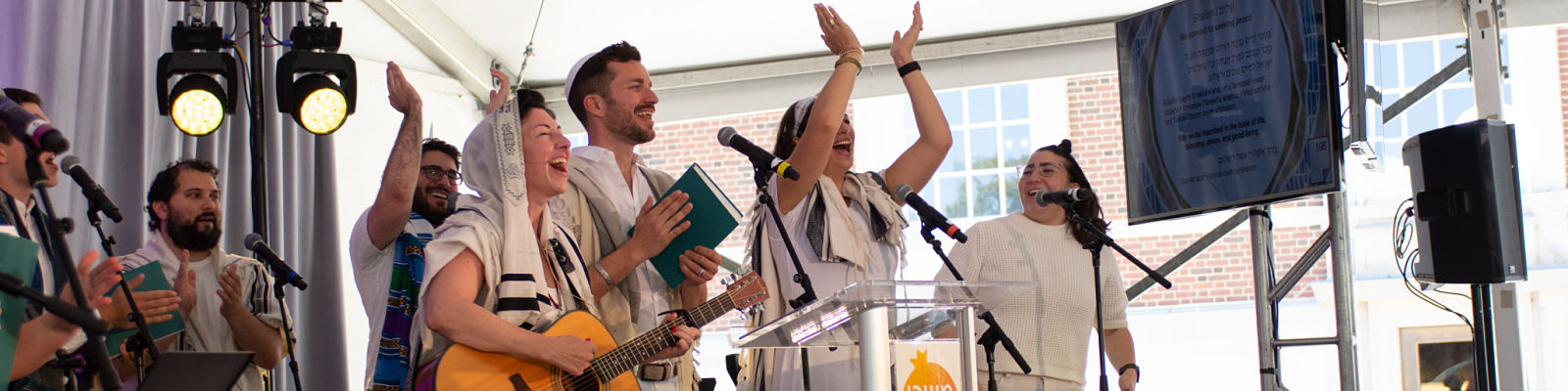 Join Rabbi Micah Shapiro and Rabbi Lizzi in learning old and new tunes. Photo: R'Lizzi & R'Steven singing with Davening Team at High Holiday service.