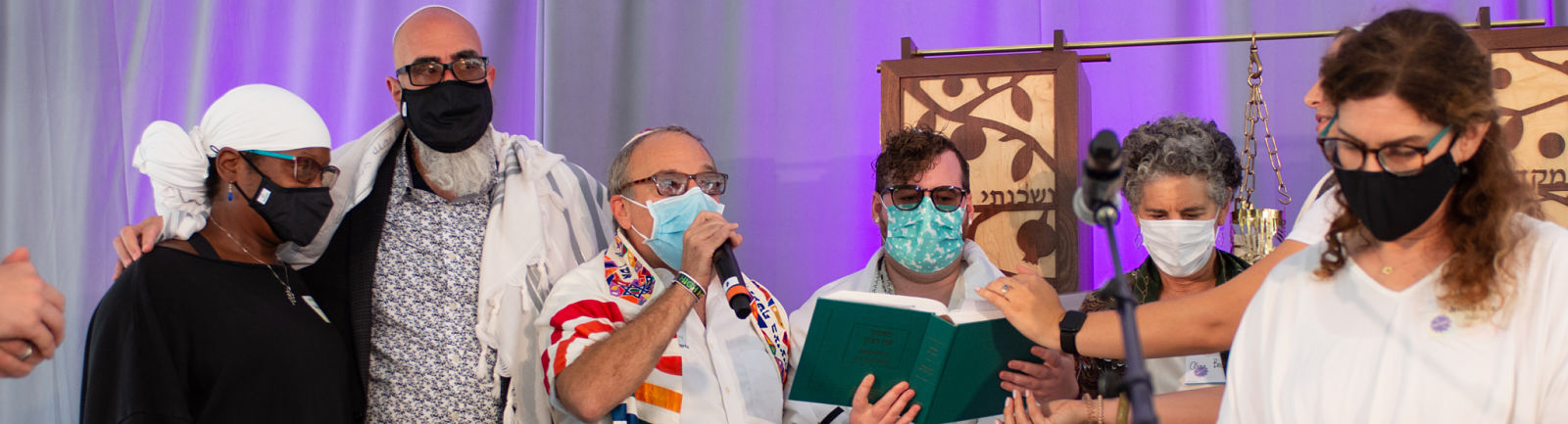 Join Rabbi Micah Shapiro and Rabbi Lizzi in learning old and new tunes. Photo: R'Lizzi & R'Steven singing with Davening Team at High Holiday service.